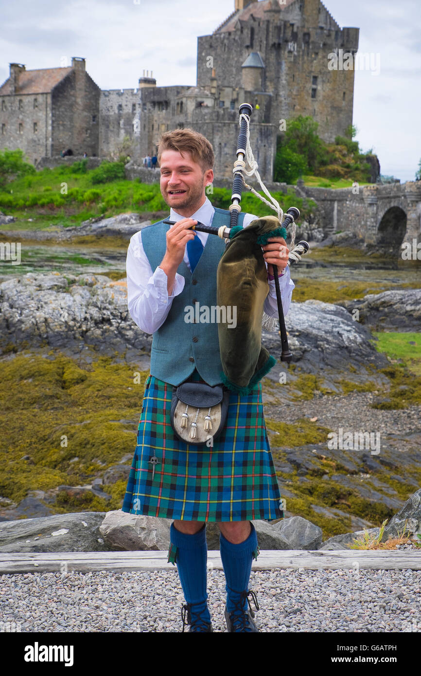 young man in traditional scottish kilt with bagpipe in front of eilean G6ATPH