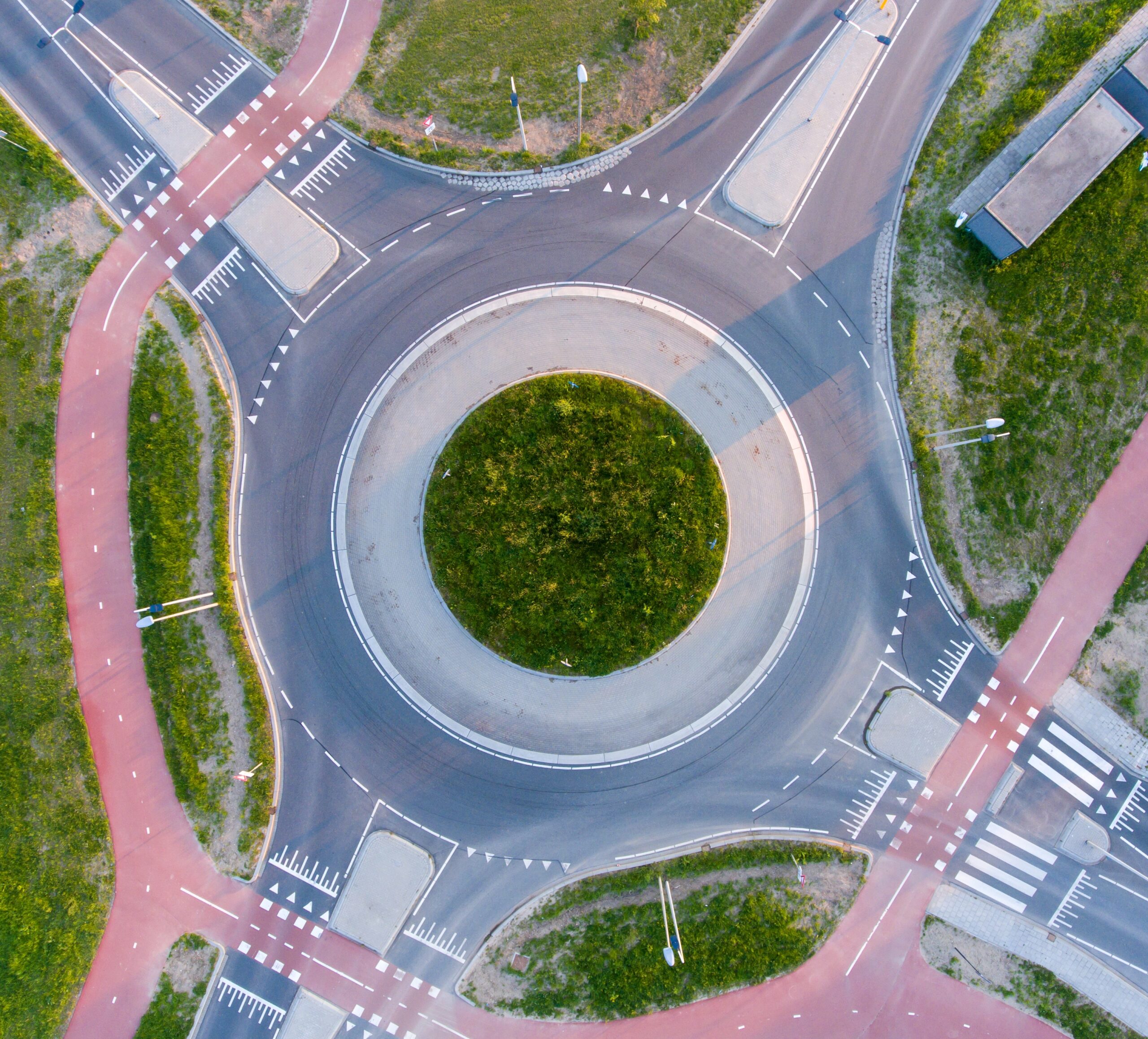 aerial shot roundabout surrounded by greenery sunlight daytime scaled